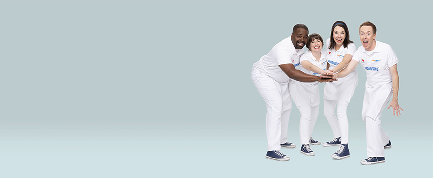 The Progressive Super Squad, consisting of Jamie, Flo, Alan, and Mara, pose with their hands stacked together for a cheer.